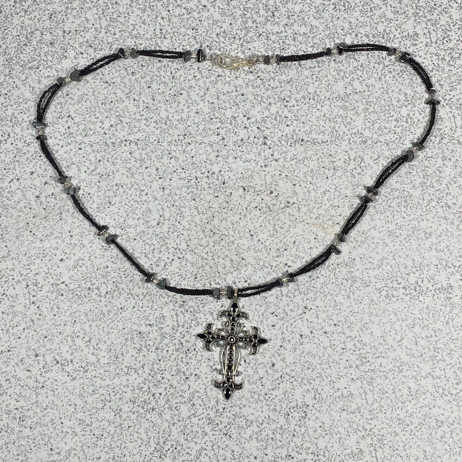 Elegant Beaded Necklace Featuring a Delicate Cross Charm