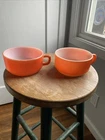 Two Vintage Anchor Hocking Fire-King orange D-handle soup bowls or chili mugs.