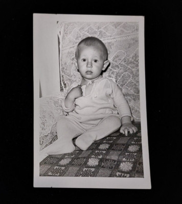 Photo of a Child in Memory of 1.5 years of life against the background of a sofa