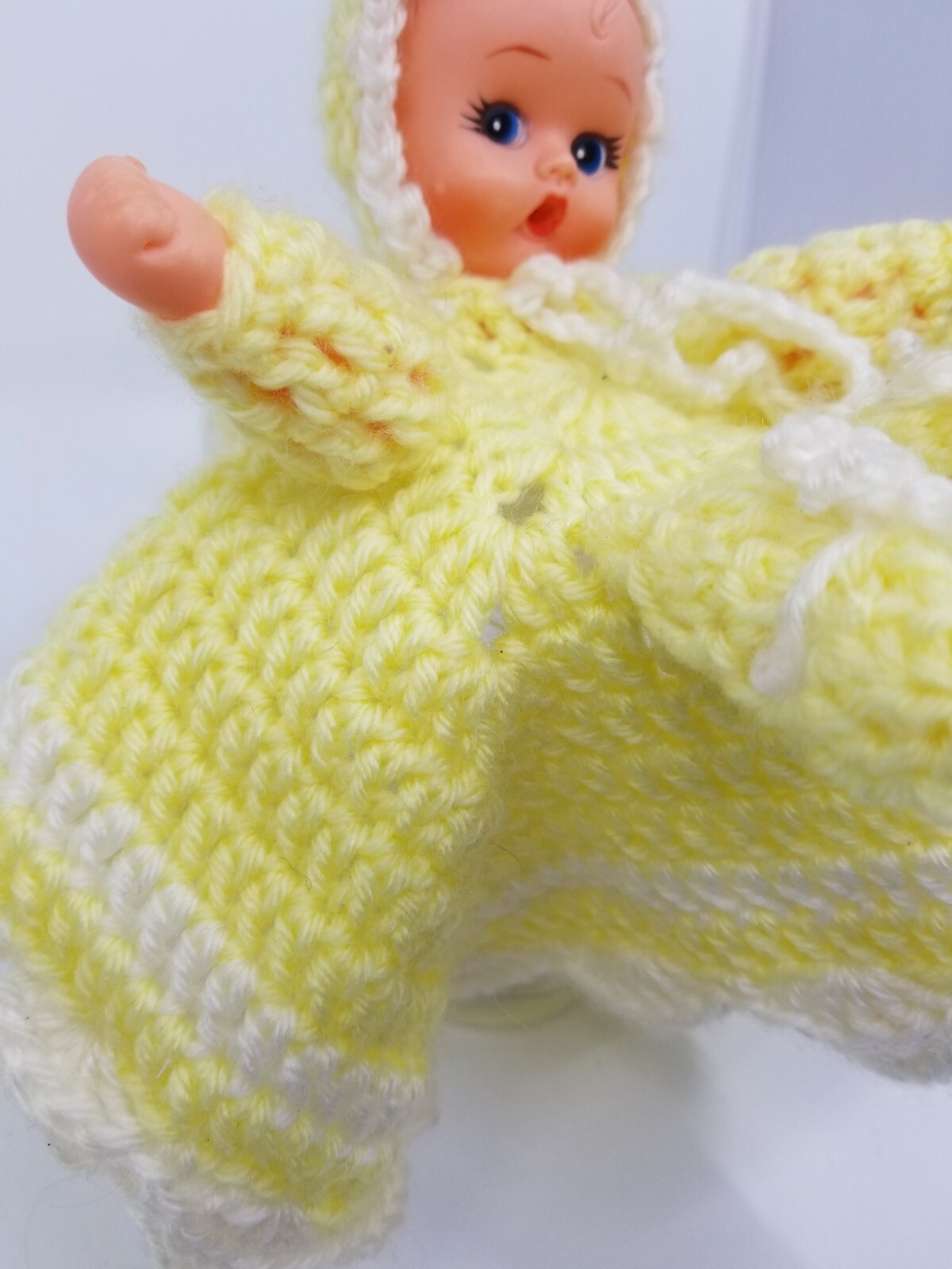 Retro crocheted toilet paper roll cover baby doll with yellow and white