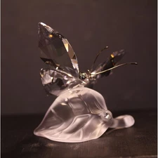 Swarovski Retired butterfly resting on a frosted crystal leaf #A 7615 NR 000 003