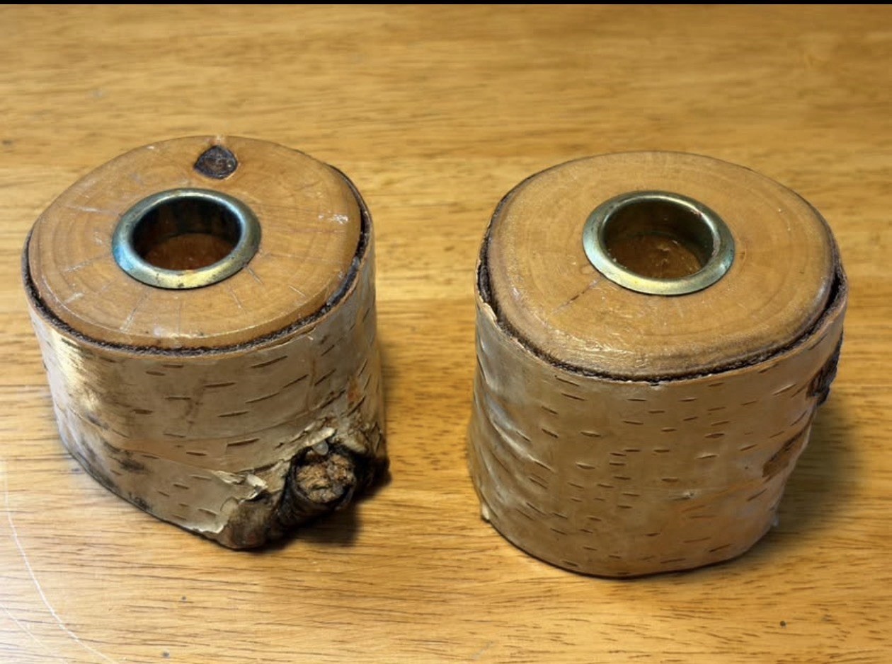 Two small hand-carved birch bark candle holders with metal votive inserts
