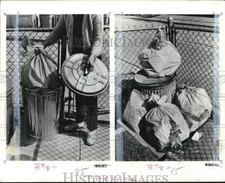 1970 Press Photo Person puts trash in bin & garbage stock outside refuse storage