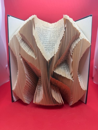 handcrafted folded book art featuring the iconic interlocking NY Yankees logo