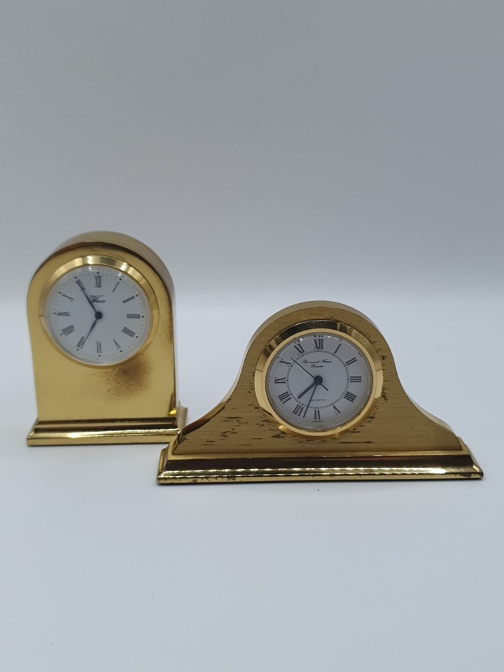 A pair of tiny vintage novelty clocks — the kind of whimsical desk curiosities you never knew you needed until you saw them.