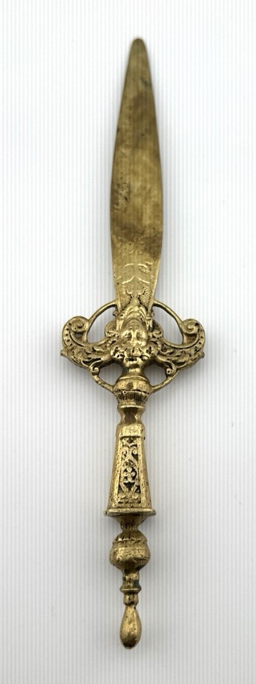 Art Nouveau dagger-style letter opener in aged bronze/brass — a functional antique that looks like it belongs in a Victorian detective's study.