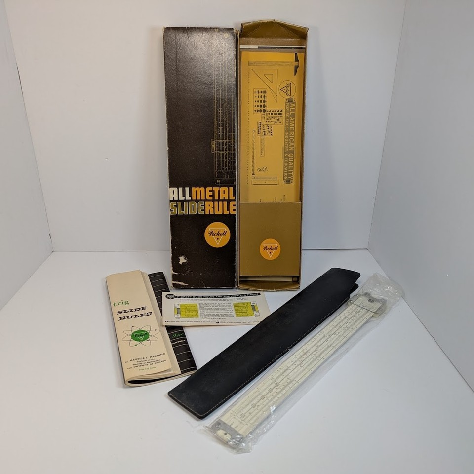 A beautifully preserved 1960s American-made metal slide rule — the pre-calculator engineer's pocket computer, complete with its original box and instructions.