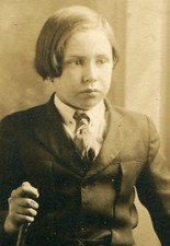 YOUNG BOY IN KNICKERS HOLDING WALKING STICK. MOODY PHOTO. TONED SILVER PRINT.