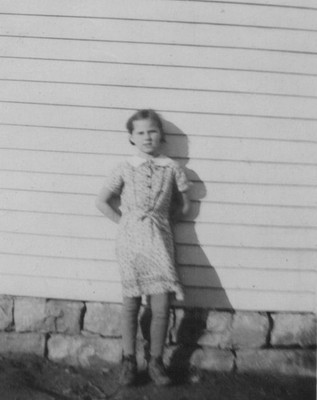 1940s Girl Portrait Siding Wall Serious Expression Rural Childhood