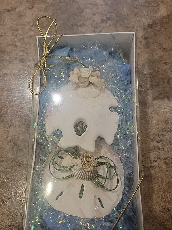 Set Of 3 handcrafted seashell ornaments featuring a sand dollar
