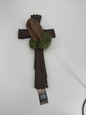 Vintage chalkware religious wall hanging with praying hands on a cross.