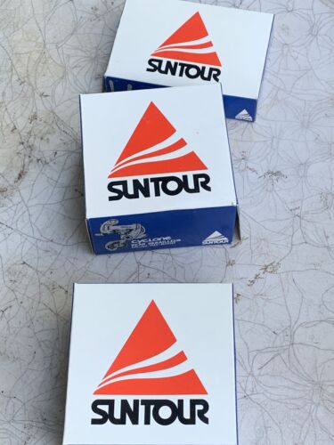 NOS Suntour front derailer, rear derailer, and down tube shifters.