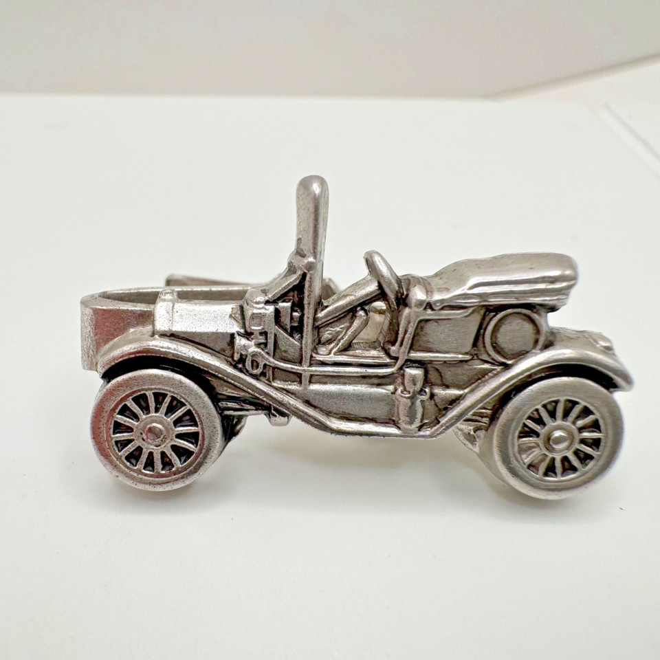 A vintage Ford Model T novelty tie bar — wearable automotive history that doubles as a tiny piece of sculpture for the car guy's lapel.
