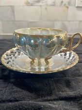 Sealy China teacup/saucer set.  Iridescent, gold trim, a footed cup, Laced Edge