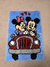 Handmade vintage latch-hook rug featuring Mickey and Minnie Mouse in a red car. 