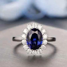 9x7mm Lab-Created Oval Cut Sapphire Halo Engagement Ring in 14K White Gold Over
