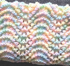 Hand knitted pastel colours newborn baby blanket 64 by 52cm.