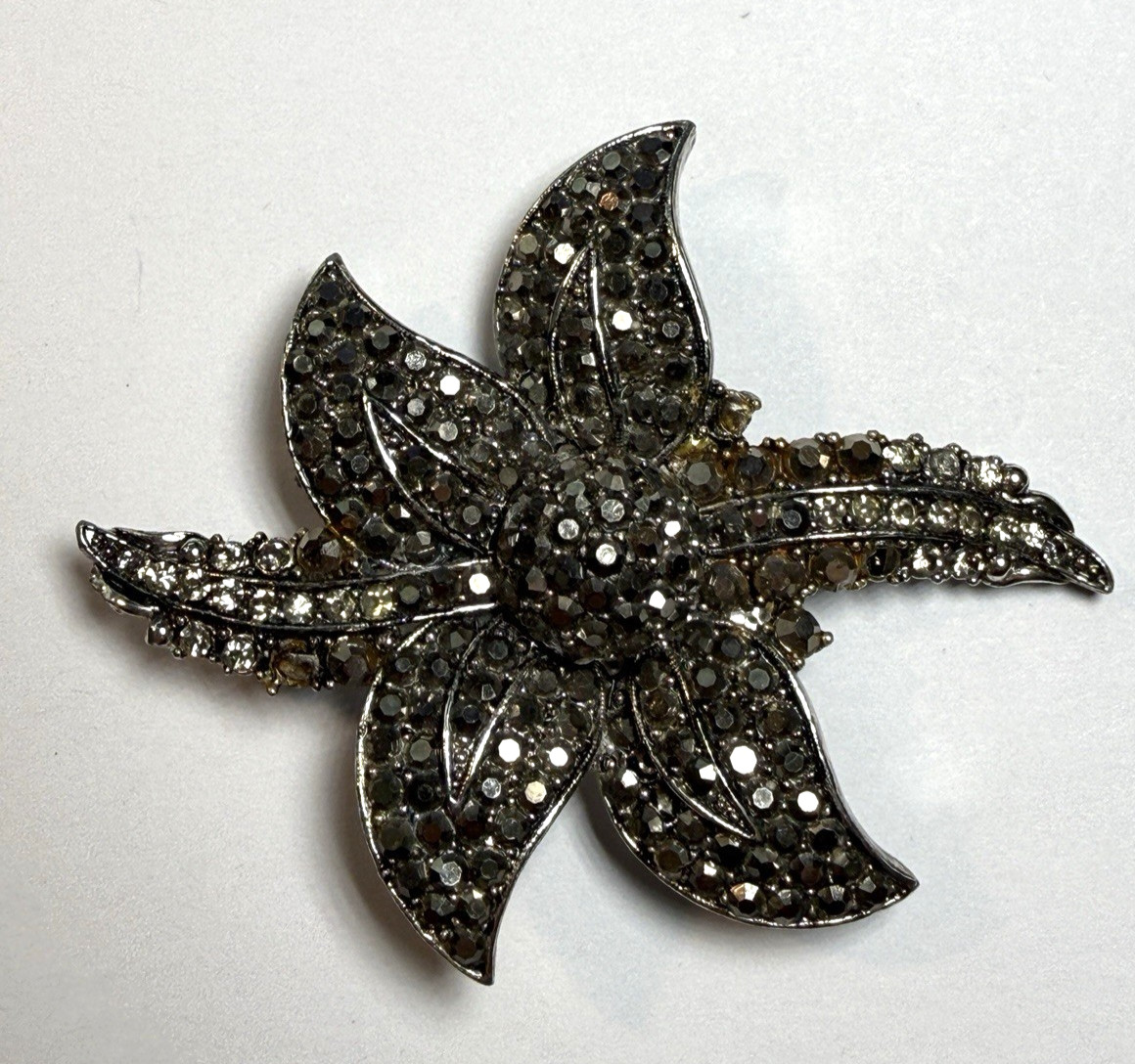 Vintage Hollycraft floral brooch with pave-set rhinestone petals