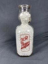 VINTAGE BABY FACE RED PYROGLAZED QUART MILK BOTTLE H.R. NOYES DAIRY HAVERHILL MA