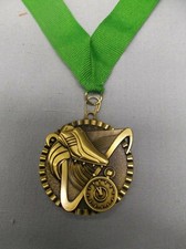 gold victory medal 2" dia track with green neck ribbon shoe and stop watch