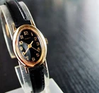 VINTAGE TIMEX ELEGANT OVAL DIAL QUARTZ WOMEN'S GOLDEN BLACK LEATHER DRESS WATCH
