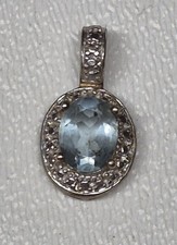 Blue Stone Surrounded by White Stones Set in Silver Pendant