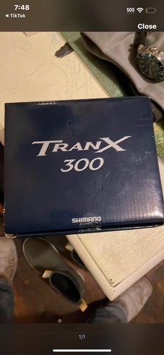 NIB SHIMANO TRANX 300 W/shimano reel cover & 20# braid