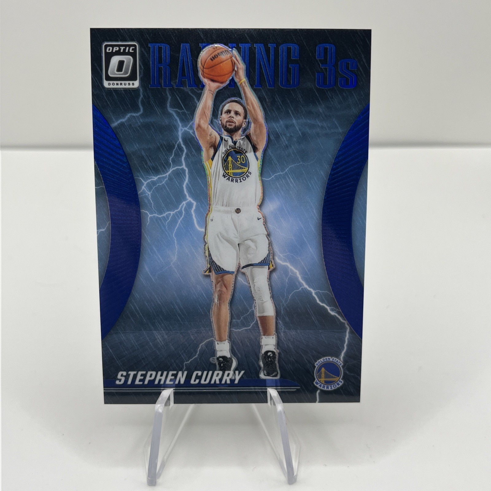 2023-24 Panini Donruss Optic - Raining 3s Stephen Curry #9 Blue Prizm /49