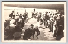 US Navy Sailors in a Relay Race or Game on a Warship's Deck Real Photo Postcard