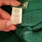White fabric tag on green Vtg 90s Ralph Lauren women’s 1/4 zip pullover with USA Made label and product details.