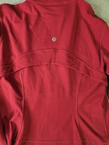 Red Lululemon Define Cropped Jacket with Nulu fabric, back seam detail, and small circular logo near upper center.