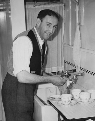 English footballer Freddie Cox of Arsenal does washing up at home - Old Photo