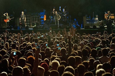 Eddie Vedder of Pearl Jam asks audience members to raise their han- Old Photo