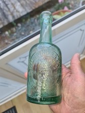 PICTORIAL HALF PINT BEER BOTTLE FROM GLOSSOP IN VERY GOOD CONDITION.