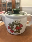 A vintage McCoy Pottery 'Strawberry Country' ceramic teapot with a green lid.