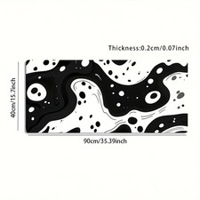 A Large Gaming Mouse Pad Featuring a Black And White Polka Dot Fluid Abstract
