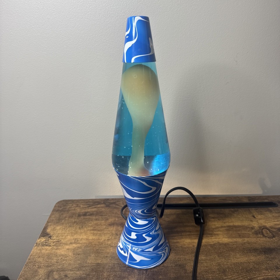 A vintage Lava Lite Model 7003 with a psychedelic blue-and-white swirl pattern — a specific collectible model with genuine 70s character.