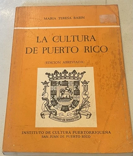 Orange book cover with black and yellow shield design, titled “La Cultura de Puerto Rico” in white text.