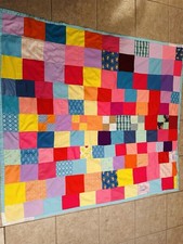A handmade patchwork quilt with diverse fabric squares.