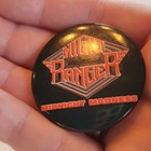 Round black pin back with white “Night Ranger” text, red “Midnight Madness” lettering, and orange star-shaped emblem.