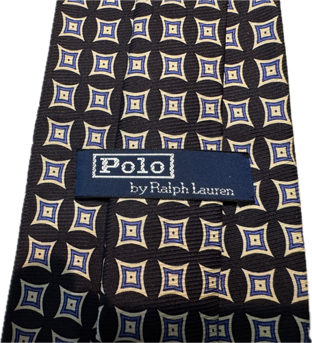 Navy silk tie with white geometric diamond pattern, blue and white labels reading “Polo by Ralph Lauren.”