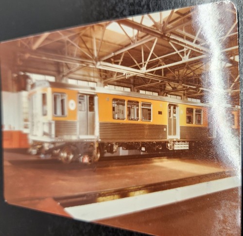 Vintage Train Photo With Yellow & Silver Train In Maintenance Garage