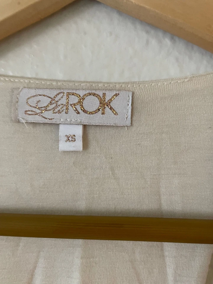 Blusa sin mangas con cuello en V acanalado La ROK talla XS espalda deportiva volantes dobladillo sin mangas Foto 4 de 4