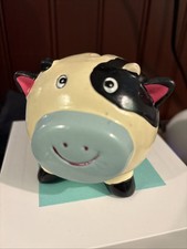 Tirelire vache ronde grosse noire et blanche avec oreilles roses et sourire vintage