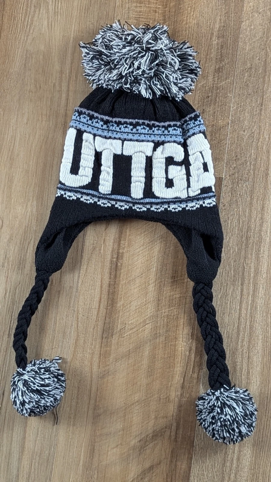 Stuttgart Knit Winter Hat by Robin Ruth – Black Fleece with Ear Flaps & Pompoms