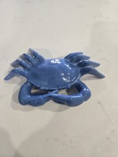 Decorative blue crab figurine used for nautical or coastal themed home decor.