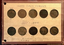 Lot of (10) Hard Times Tokens in a Vintage Wayte Raymond Board