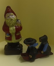 Antique Cast Iron Santa Claus holding Doll Figurine  Amish cast iron sled kids