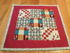 Quilted Table topper, red frame, cherry and people squares, 15 x 15.5