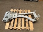Silver 13-18 RAM 1500 front left driver frame apron radiator support with exposed bolts and wiring on a wooden pallet.